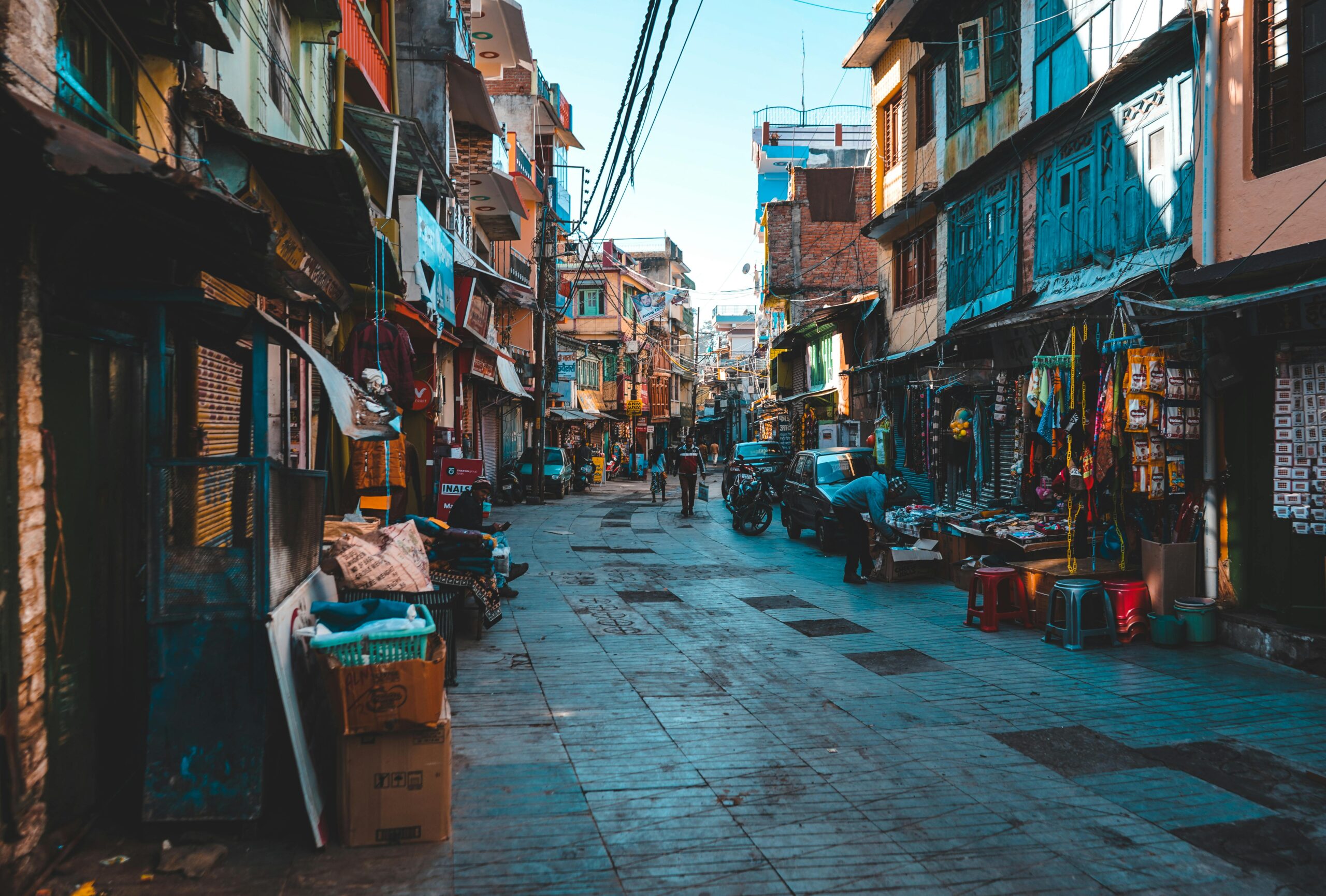 A vibrant Indian street market with shops and people, showcasing daily urban life.